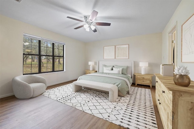 bedroom with light hardwood / wood-style flooring and ceiling fan