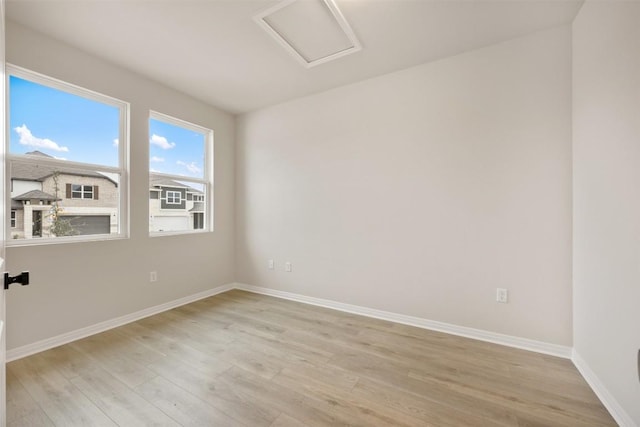 727 Palo Brea Loop, Hutto, TX 78634 - empty room with attic access, light wood finished floors, and baseboards