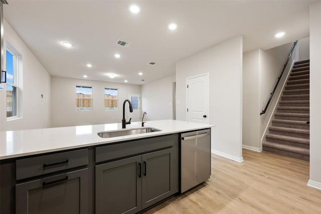 727 Palo Brea Loop, Hutto, TX 78634 - kitchen featuring a sink, stainless steel dishwasher, gray cabinets, light wood-style flooring, and baseboards