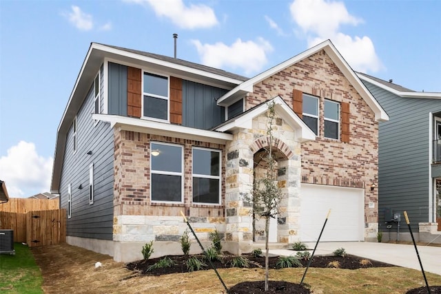 727 Palo Brea Loop, Hutto, TX 78634 - view of front of house with an attached garage, driveway, stone siding, board and batten siding, and brick siding