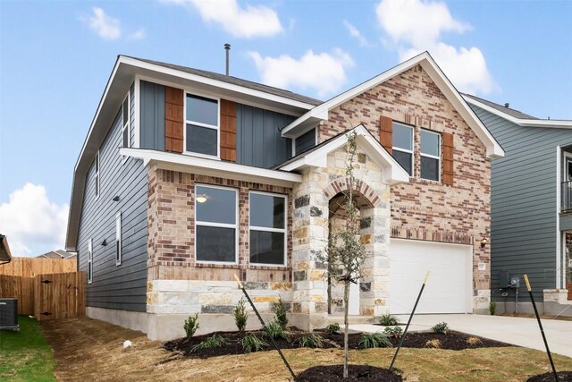 727 Palo Brea Loop, Hutto, TX 78634 - view of front facade with an attached garage, concrete driveway, stone siding, board and batten siding, and brick siding