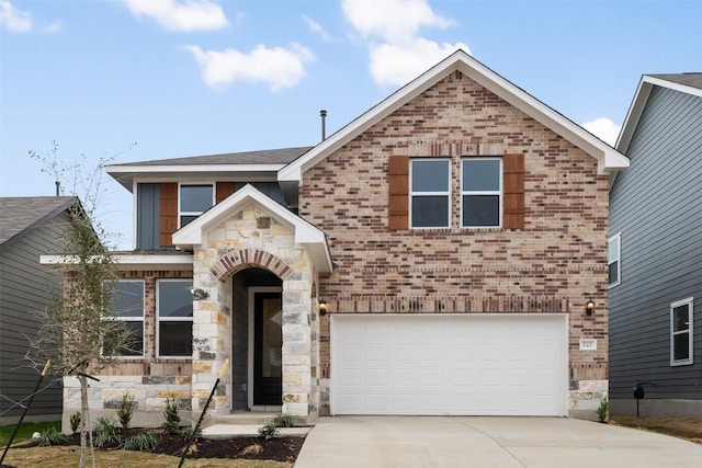 727 Palo Brea Loop, Hutto, TX 78634 - view of front of house featuring driveway, a garage, brick siding, and stone siding
