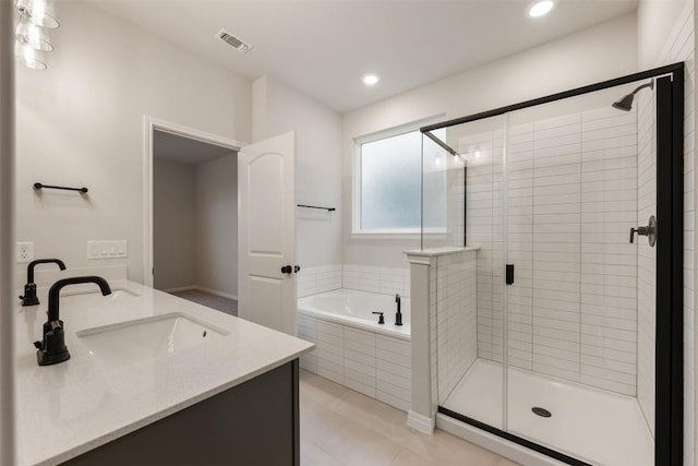 727 Palo Brea Loop, Hutto, TX 78634 - bathroom with a garden tub, a stall shower, double vanity, recessed lighting, and tile patterned flooring