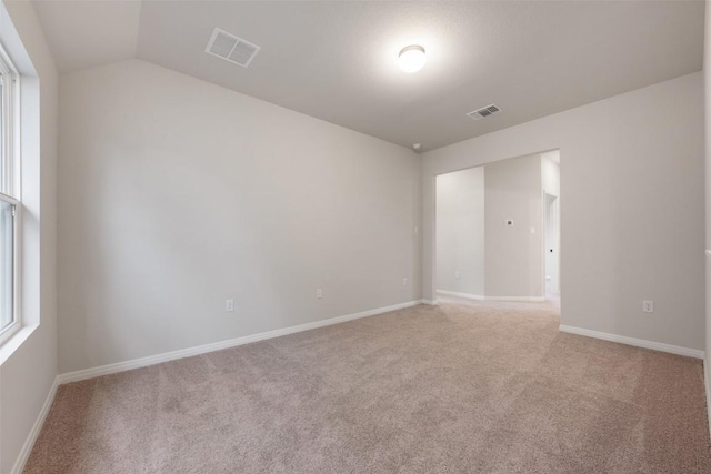 727 Palo Brea Loop, Hutto, TX 78634 - unfurnished room featuring light colored carpet, vaulted ceiling, and baseboards