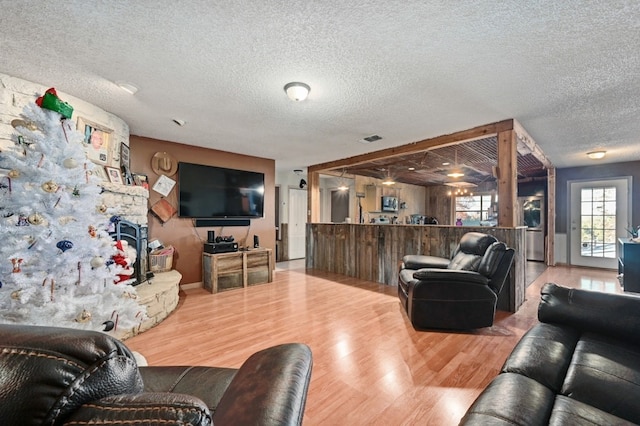 living room featuring hardwood / wood-style floors and a textured ceiling