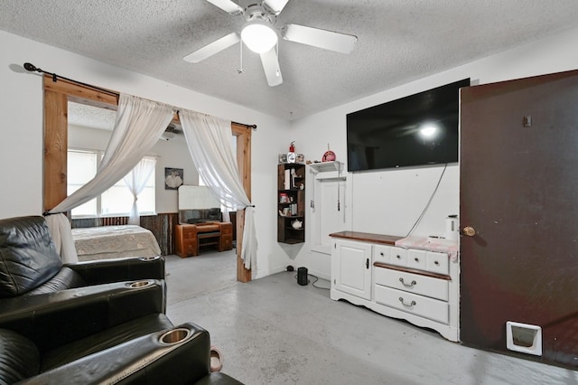 interior space with ceiling fan and a textured ceiling