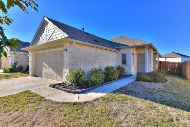 single story home with a garage and a front lawn