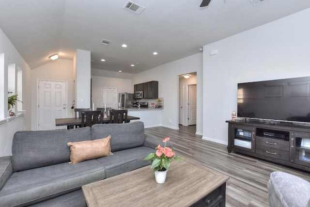 living room with light wood-type flooring and ceiling fan