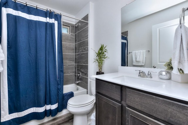 full bathroom with hardwood / wood-style flooring, vanity, shower / tub combo, and toilet