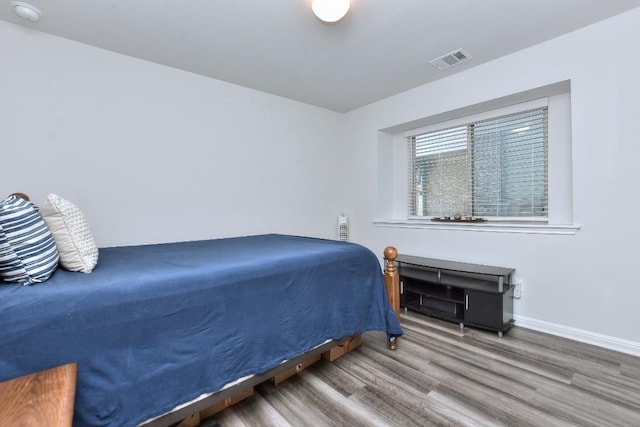 bedroom with hardwood / wood-style flooring