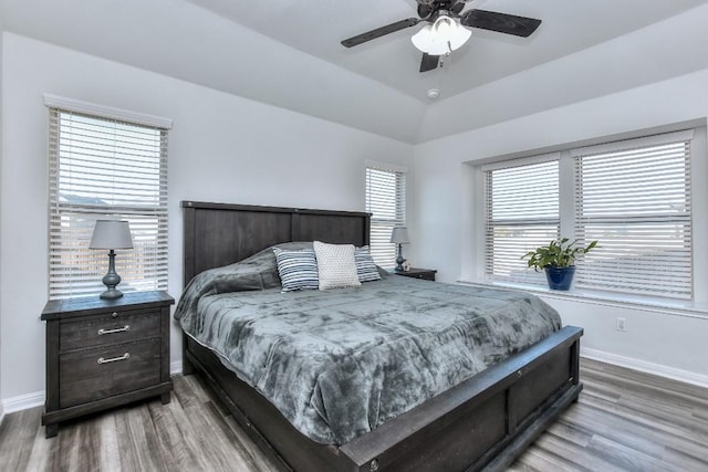 bedroom featuring lofted ceiling, wood-type flooring, and ceiling fan