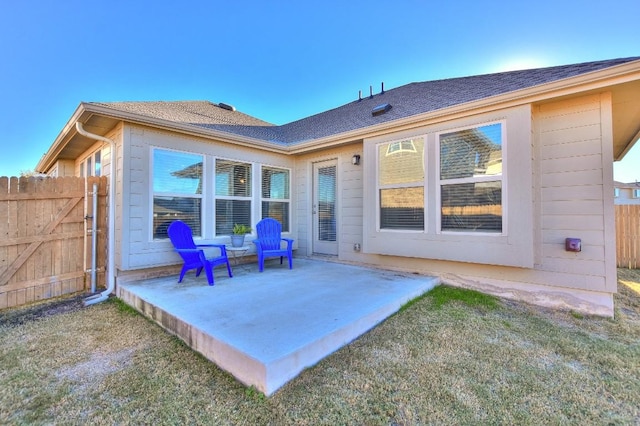 rear view of property with a patio area and a lawn