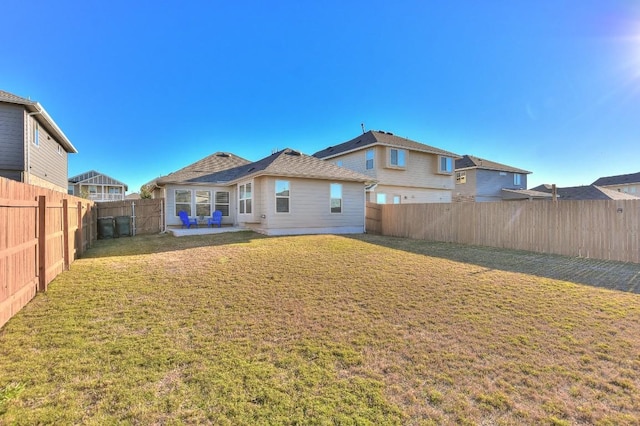 back of house featuring a yard and a patio area