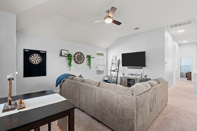 carpeted living room featuring ceiling fan and lofted ceiling