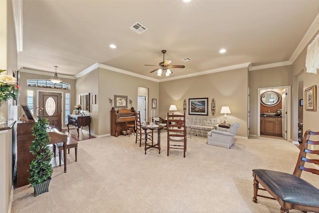 carpeted living room featuring ceiling fan and ornamental molding