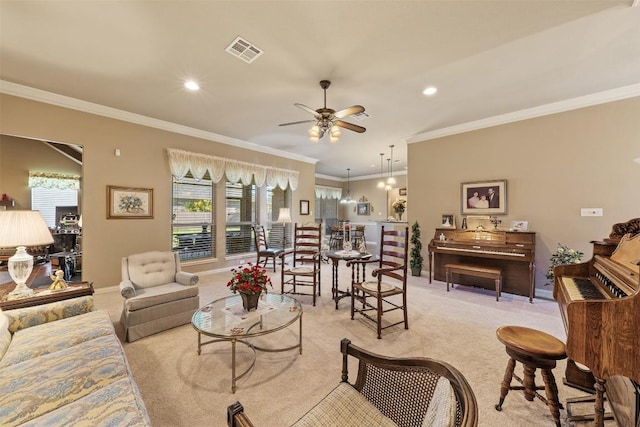 living room featuring light colored carpet, crown molding, ceiling fan, and a healthy amount of sunlight