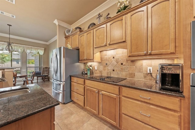 kitchen featuring crown molding, sink, black electric cooktop, decorative light fixtures, and a chandelier