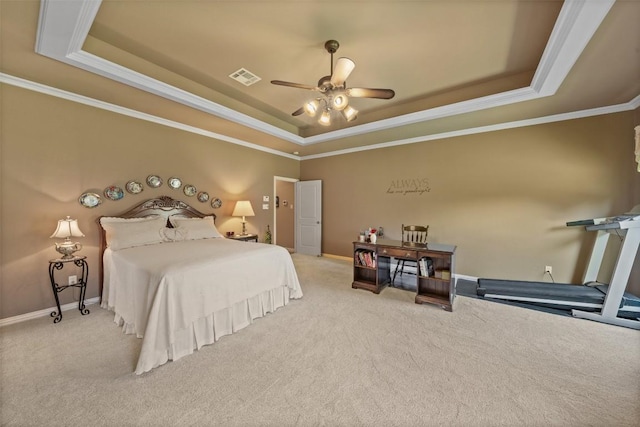 bedroom with a tray ceiling, ceiling fan, carpet floors, and ornamental molding