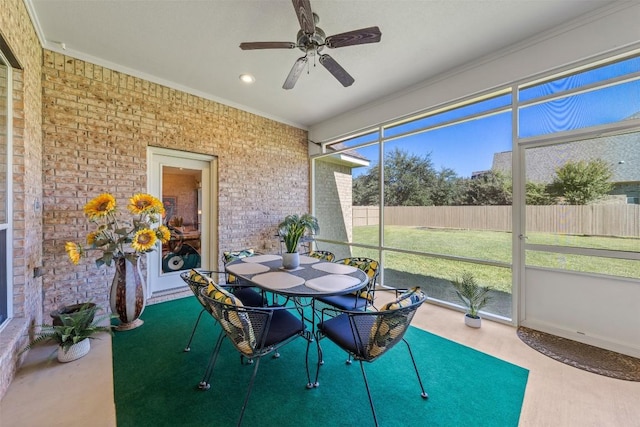 sunroom / solarium featuring ceiling fan