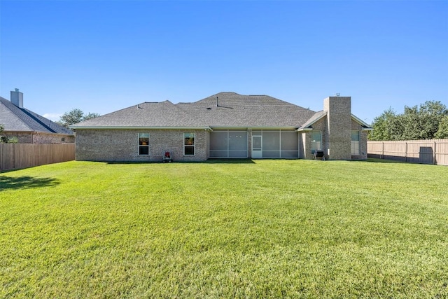 back of house featuring a lawn