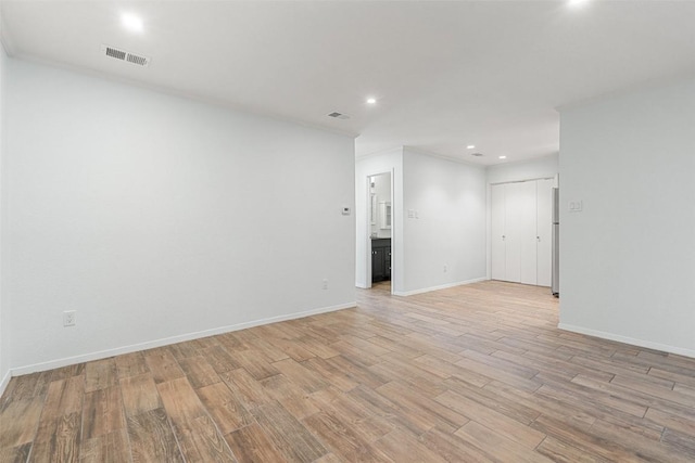 spare room featuring light hardwood / wood-style floors