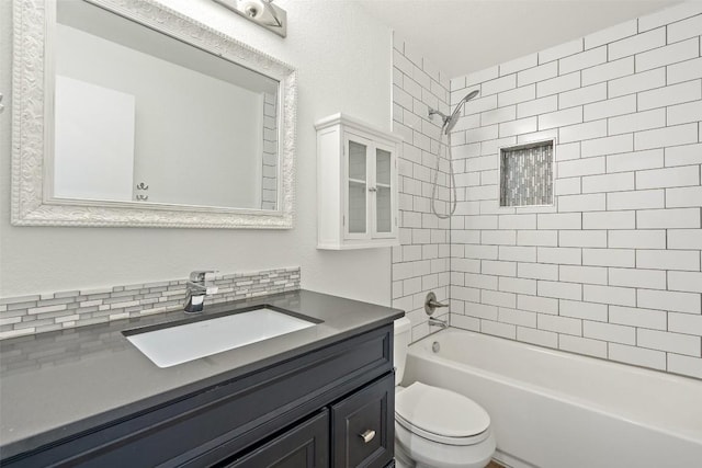 full bathroom featuring decorative backsplash, toilet, vanity, and tiled shower / bath