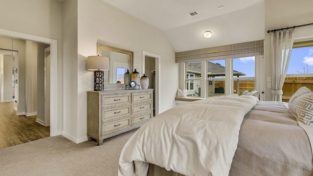 carpeted bedroom featuring access to outside and vaulted ceiling