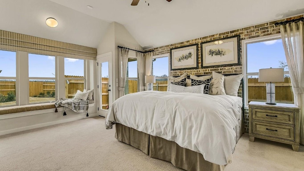 bedroom with ceiling fan, access to exterior, vaulted ceiling, and light carpet