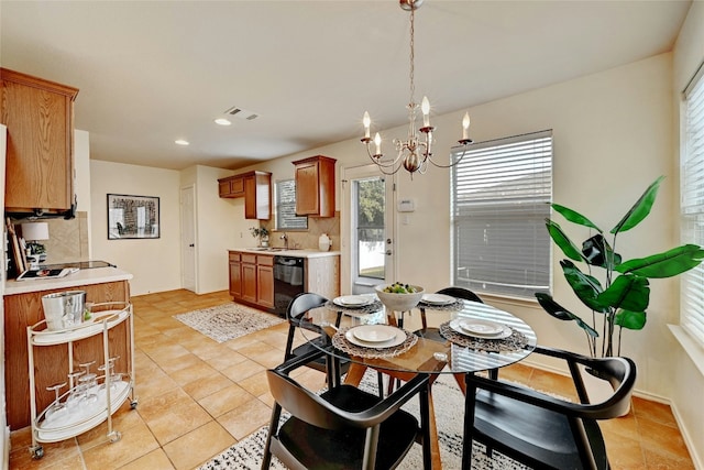 dining area featuring sink, light tile patterned flooring, and a chandelier