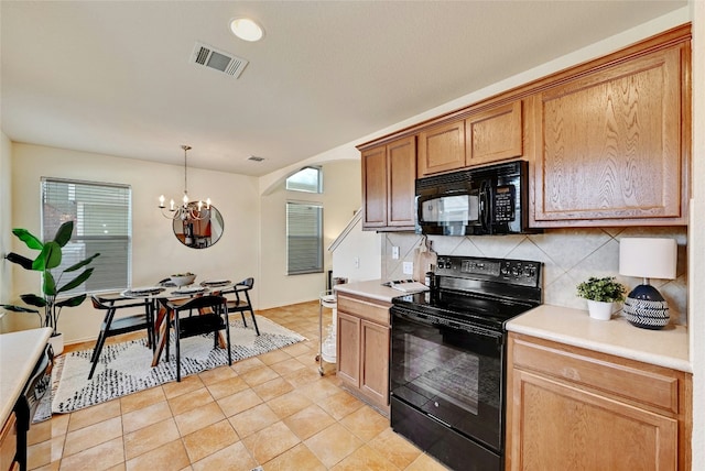 kitchen featuring an inviting chandelier, backsplash, decorative light fixtures, light tile patterned floors, and black appliances