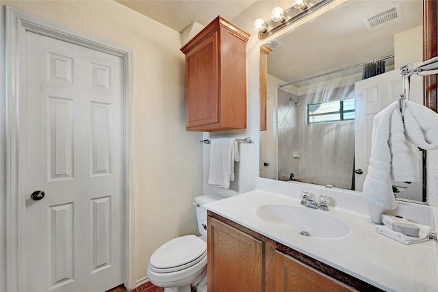 bathroom with vanity, toilet, and walk in shower