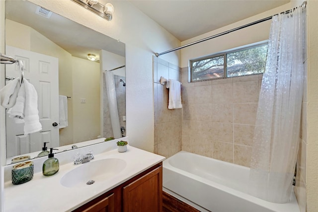 bathroom featuring vanity and shower / bathtub combination with curtain