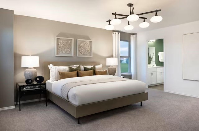 bedroom with carpet, ceiling fan with notable chandelier, and ensuite bath