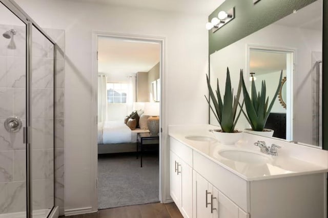 bathroom with hardwood / wood-style flooring, vanity, and a shower with door