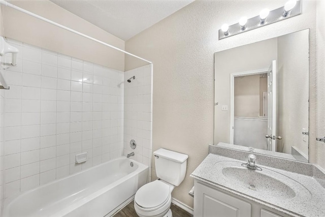 full bathroom featuring toilet, vanity, and tiled shower / bath