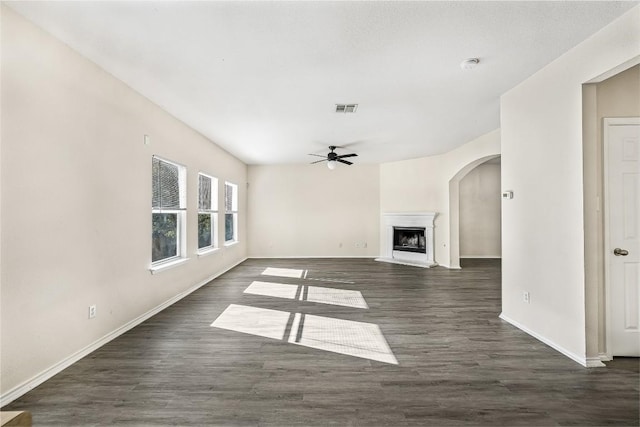 unfurnished living room featuring dark hardwood / wood-style flooring and ceiling fan