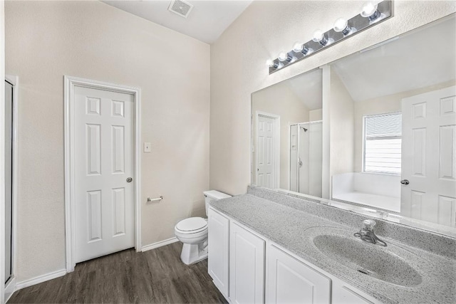 full bathroom with plus walk in shower, wood-type flooring, lofted ceiling, toilet, and vanity