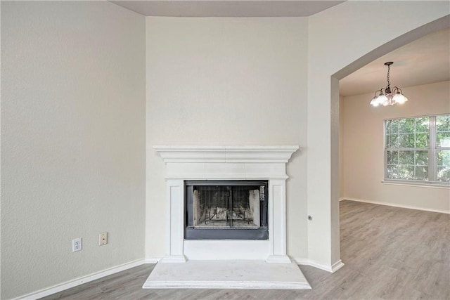 details with a chandelier and hardwood / wood-style flooring