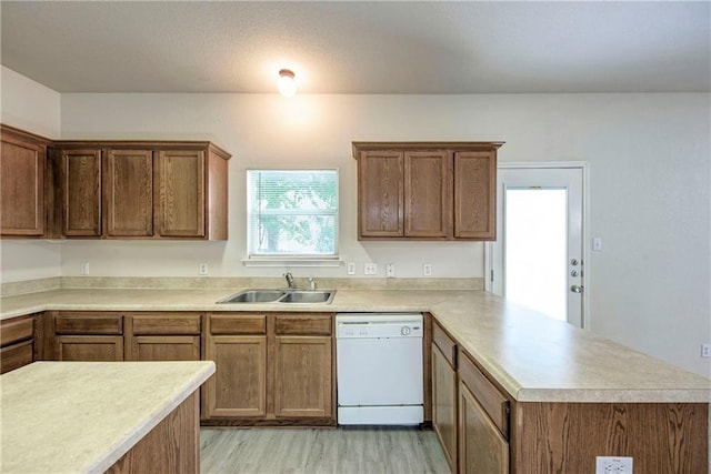 kitchen featuring kitchen peninsula, sink, white dishwasher, and light wood-type flooring