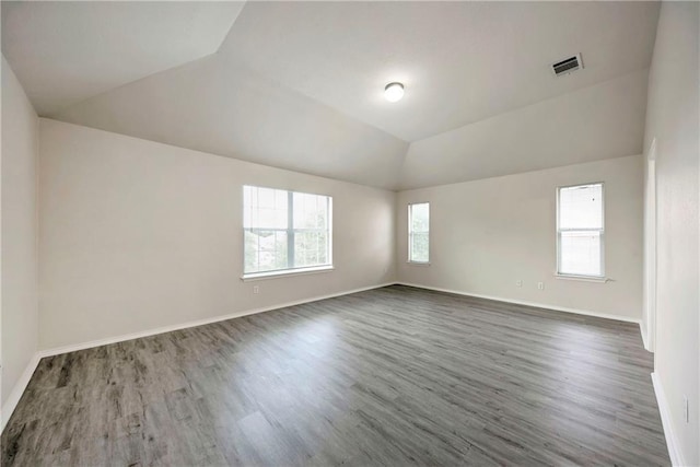 unfurnished room with vaulted ceiling and dark hardwood / wood-style floors