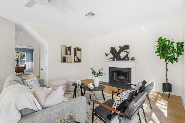 living room with ceiling fan and hardwood / wood-style floors