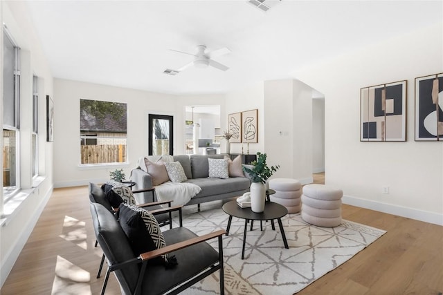 living room featuring ceiling fan and light hardwood / wood-style floors