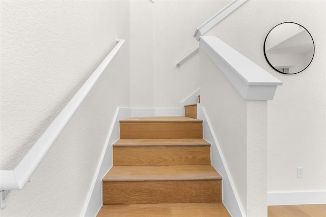 stairs with hardwood / wood-style flooring