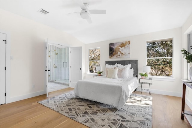 bedroom with ceiling fan, light hardwood / wood-style floors, and lofted ceiling