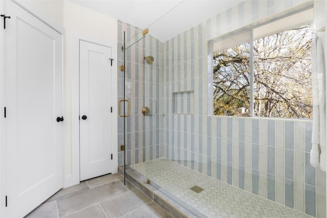 bathroom featuring tile patterned flooring and an enclosed shower