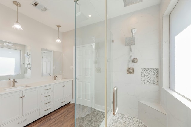 bathroom featuring vanity, wood-type flooring, and walk in shower