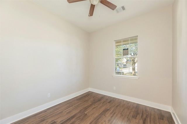 empty room with dark hardwood / wood-style floors and ceiling fan