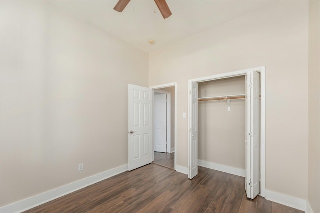 unfurnished bedroom featuring ceiling fan, dark hardwood / wood-style floors, and a closet