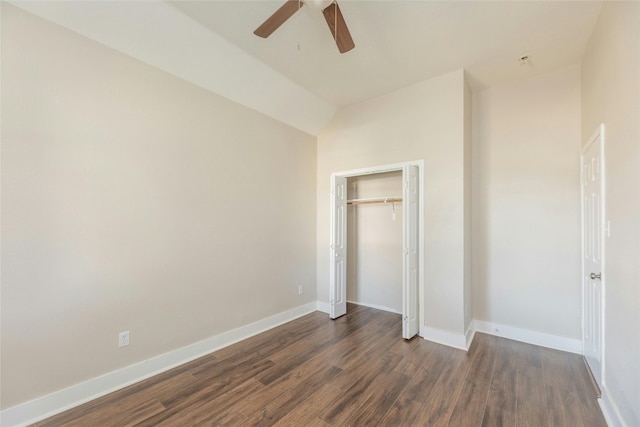 unfurnished bedroom featuring a closet, dark hardwood / wood-style floors, ceiling fan, and lofted ceiling