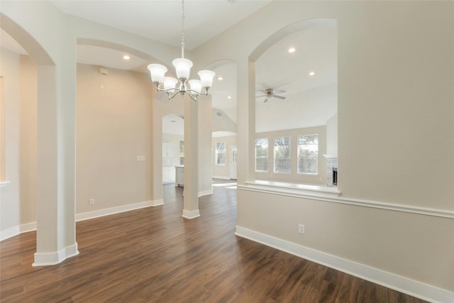 interior space with dark wood-type flooring and ceiling fan with notable chandelier